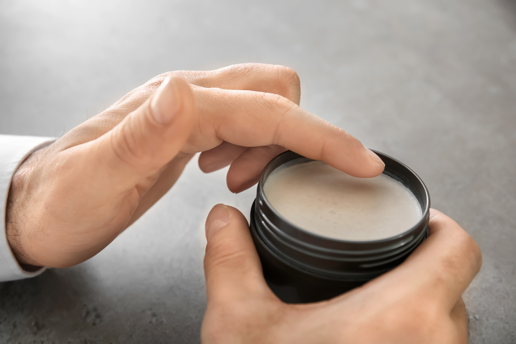 Male Hands with Jar of Clay for Hair